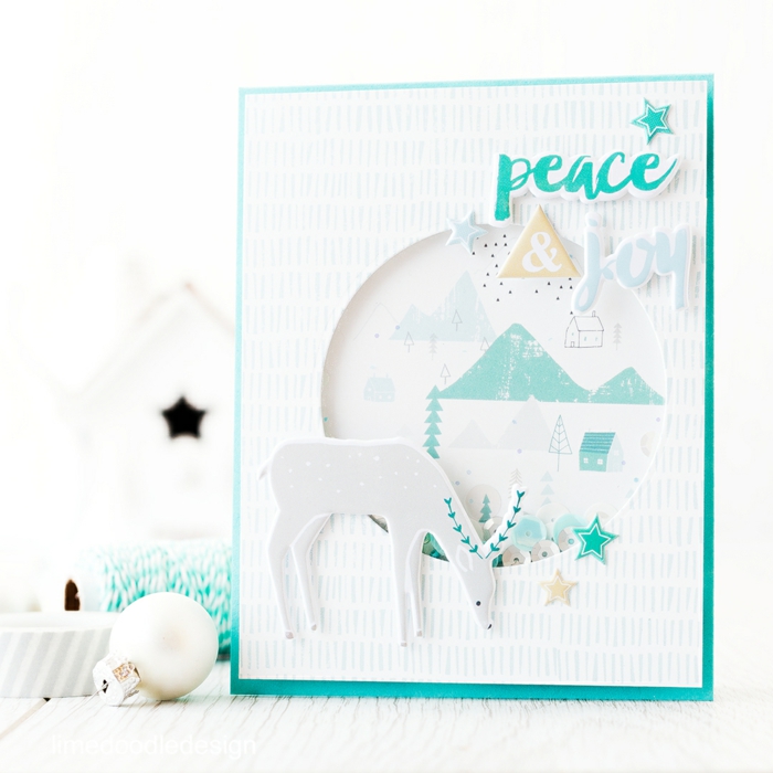 weiße Karte mit blauem Aufschrift Frieden und Freude, ein Renntier, lustige Weihnachtskarten