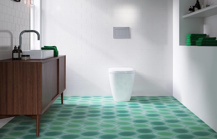 braunes waschbecken im modernen badezimmer mit einem grünen boden und weißen badezimmer fliesen