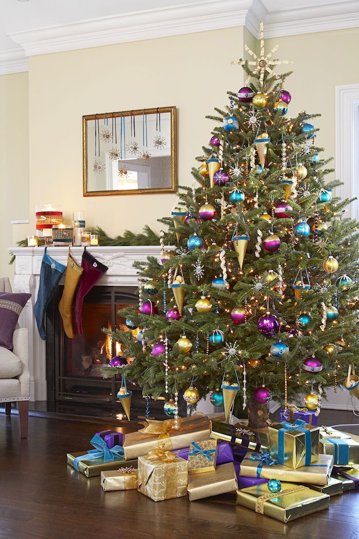 Großer Weihnachtsbaum mit viel Schmuck, Weihnachtsstrümpfe am Kamin, viele Geschenke unter dem Baum 