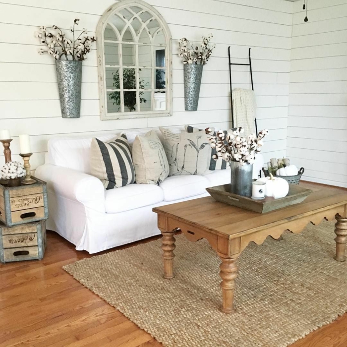 weißes Sofa, ein brauner Teppich, ein brauner Tisch, braune Kissen, zwei Vasen mit Blumen, Wohnzimmer Ideen Wandgestaltung