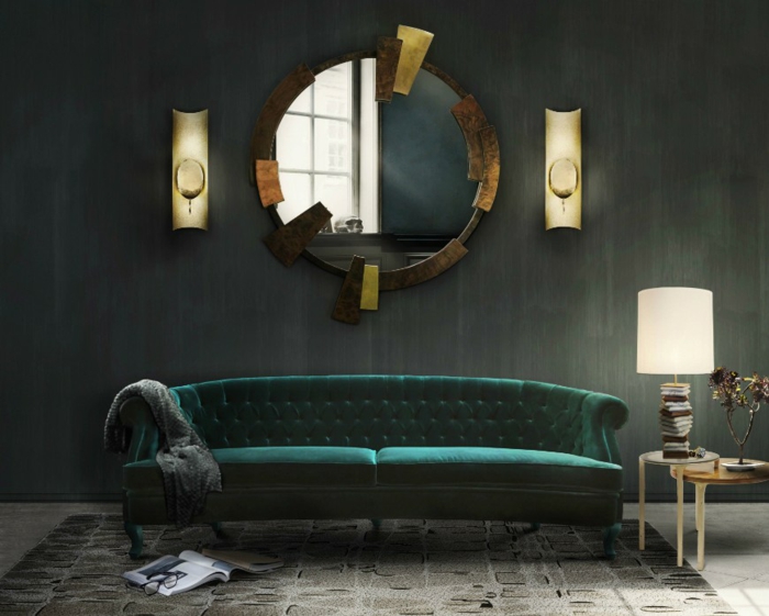ein runder Spiegel mit ausgefallenen Rahmen, ein grünes Sofa, ein grauer Teppich, Wandgestaltung Ideen selber machen