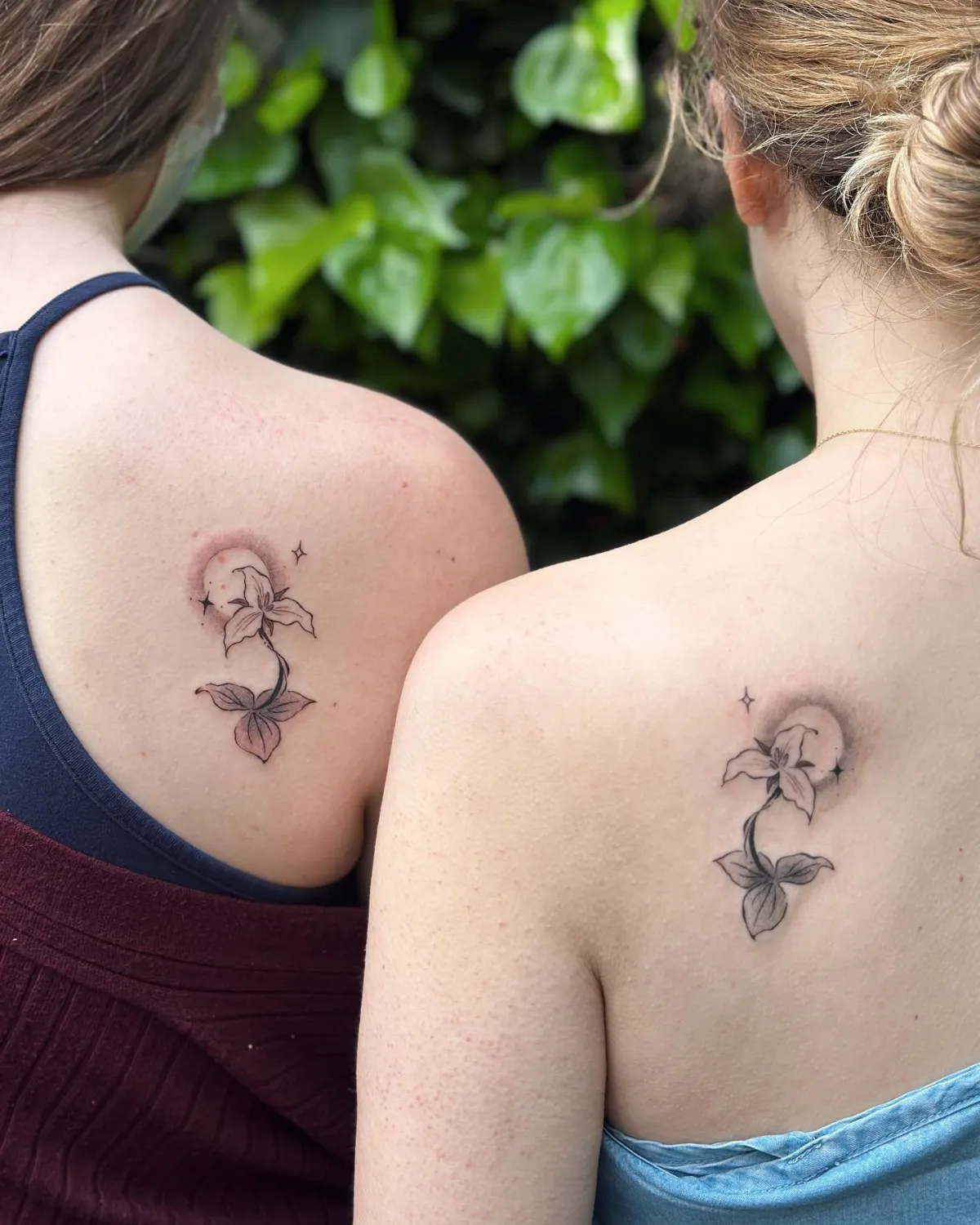 rücken tattoos mit lilie und mond fuer zwillingsschwestern