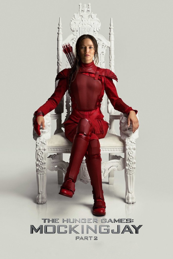 großer weißer stuhl, eine junge frau mit roten stiefeln und einem roten kostüm aus ledder, die schauspielerin jennifer lawrence als katniss everdeen