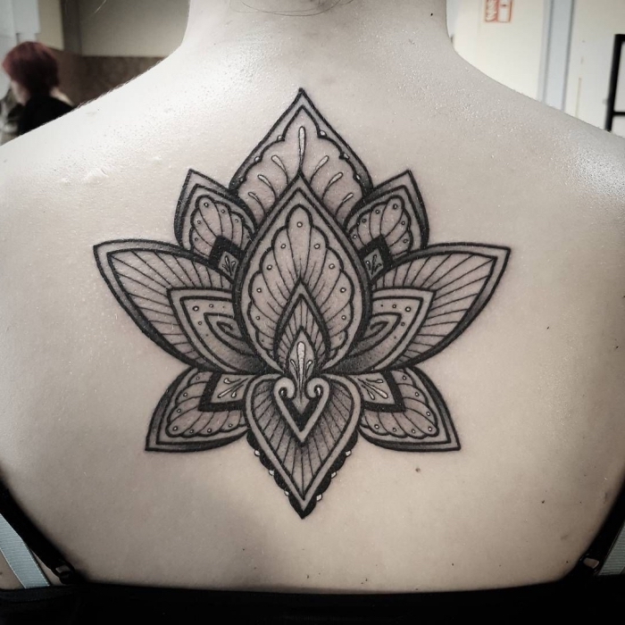 frau mti großer tätowierung am rücken, mandala tattoo bedeutung, blackwork lotusblume 
