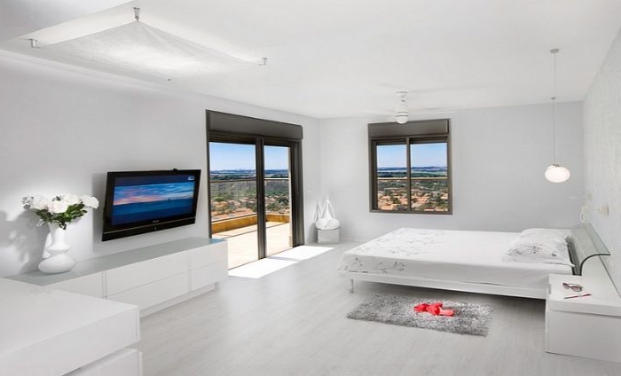 minimalistisch leben, schlafzimmer in simplem weißen design, ein doppelbett, fenster, fernseher
