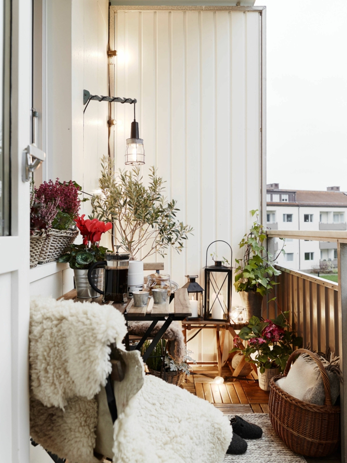 Ikea Balkon Ideen, cozy Gestaltung von Terrasse, viele Laternen, kuschelige Decke, beiger Teppich, 