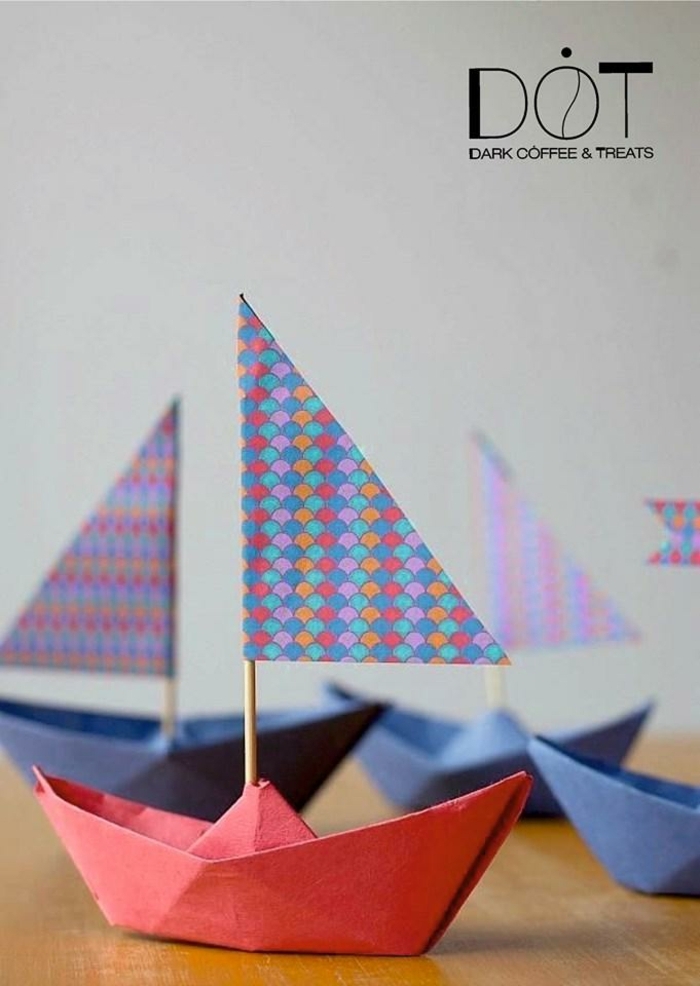 Origami Anleitung zum basteln von einem Boot aus rotem Karton mit Fahne, basteln mit Kindern