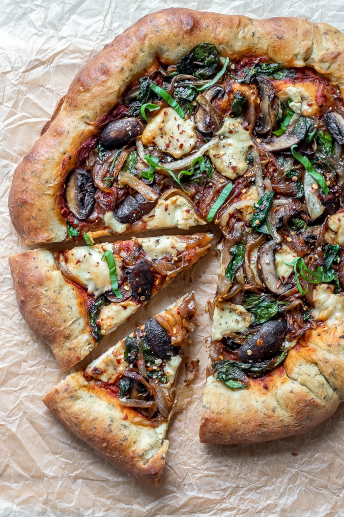 selbstgemachte vegane Pizza mit Champignons und Gemüse und veganem Mozzarella, vegane Hauptgerichte für Gäste