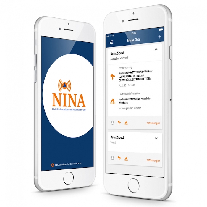 ein smartphone mit der kostenlosen anwendung nina, die vor ausbrüche des aktuellen coronavirus warnen