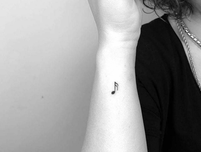 minimalistische note tattoo kleine tattoos mit bedeutung handgelenk dame im schwarzen t shirt