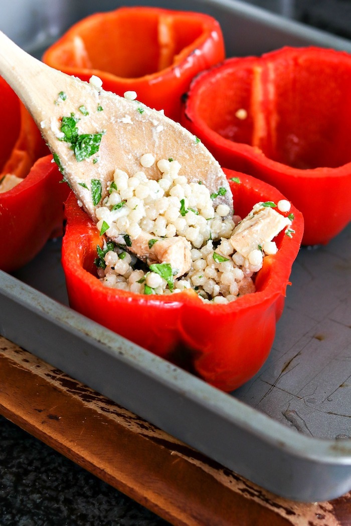 wie macht man gefüllte paprika ein löffel aus holz topf mit roten paprikaschoten gefüllte paprika