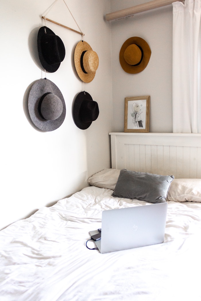 moderne ausstattung schlafzimmer wandgestaltung jugendzimmer aufgehängte hütten grauer kissen weiße bettwäsche laptop auf bett