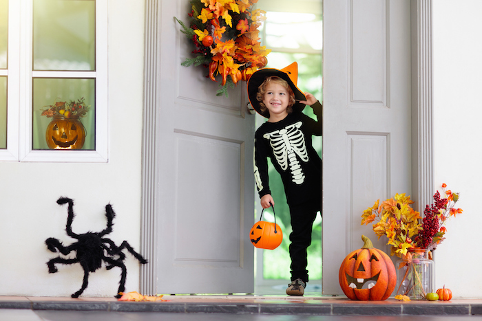 kids trick or treat. halloween. child at door.