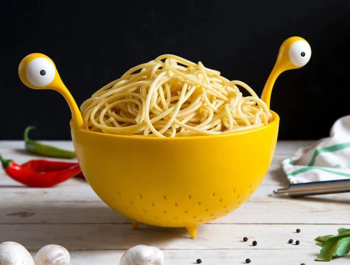 pasta monster eine gelbe schüssel und gelbe löffel und gabel mit großen weißen augen