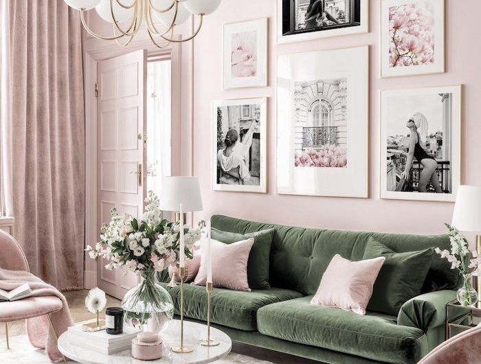 wandfarbe rosa grünes sofa mit pinken und grünen kissen runder tisch vase mit blumen wanddekoration wohnzimmer schwarz weiße fotos moderne inneneinrichtung inspiration