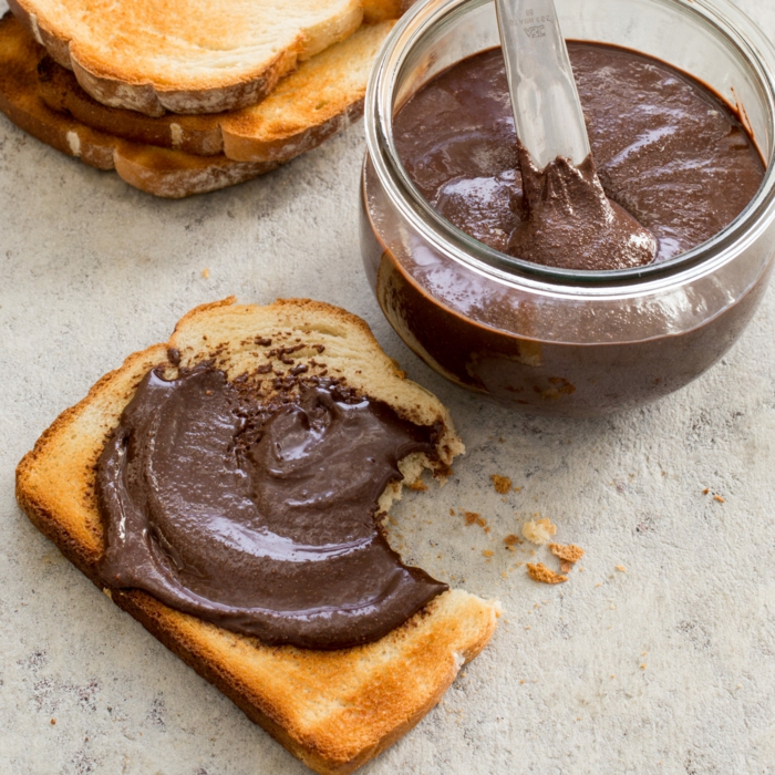 glas mit einem löffel aus metall und einer nutella alternative brot mit pasta