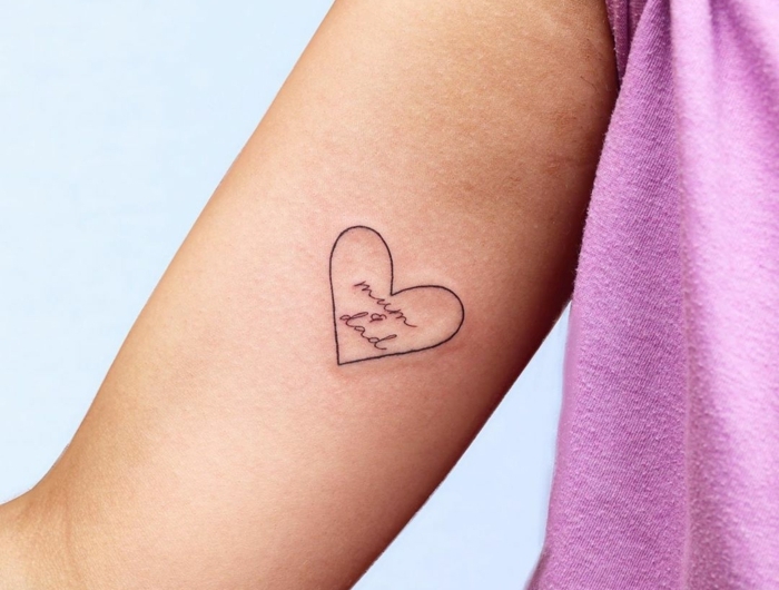 kleines minimalistisches mama papa tattoo am arm in einem herz lila t shirt