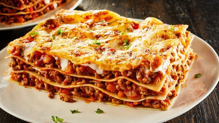ein stück lasagne mit hackfleisch und käse lasagne selber machen rezept tomaten und petersilie