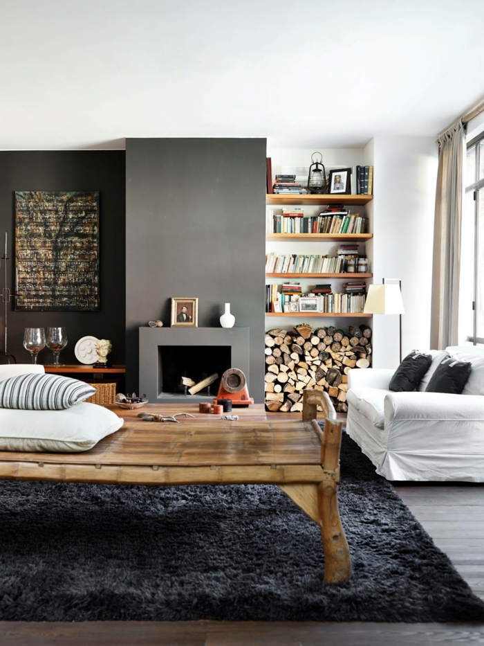 flauschiger dunkler teppich großer tisch aus holz kleines weißes sofa wohnzimmer skandinavischer stil mit kamin inneneinrichtung 2021 modern