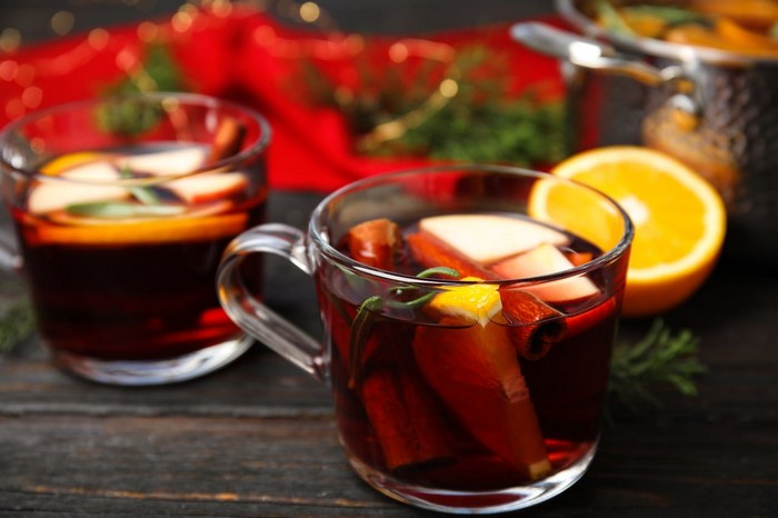 tasty mulled wine with spices on wooden table