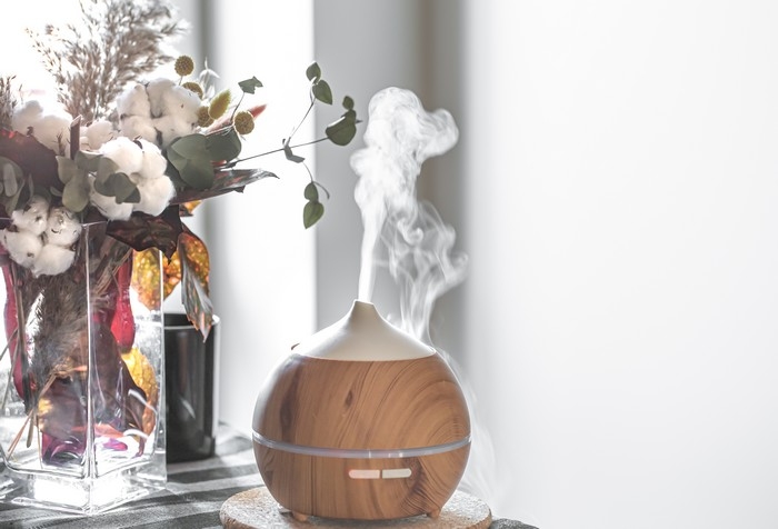 modern oil aroma diffuser in the living room on the table copy space.