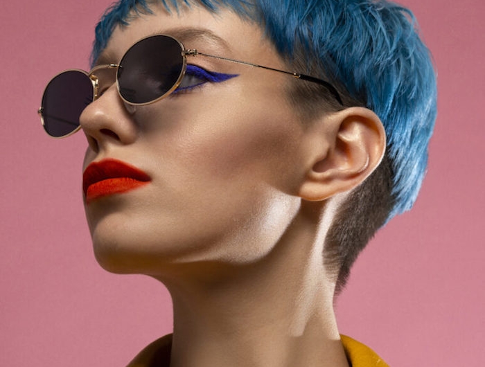 blue hair girl in sunglasses wearing yellow jacket