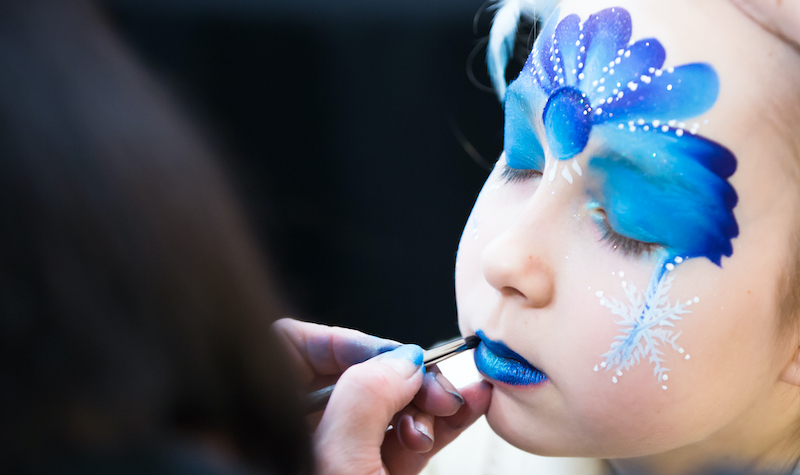 portrait of little girl during the face painting session