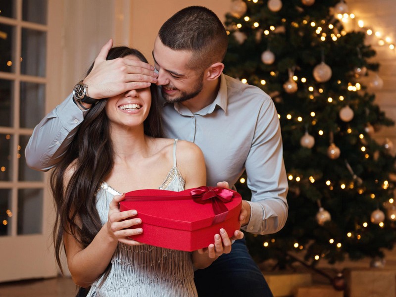 man giving a christmas present to his girlfriend