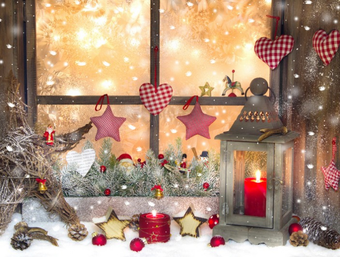 red christmas decoration with lantern on window sill with wood
