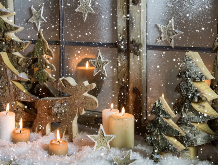 natural christmas window decoration of wood with snow.