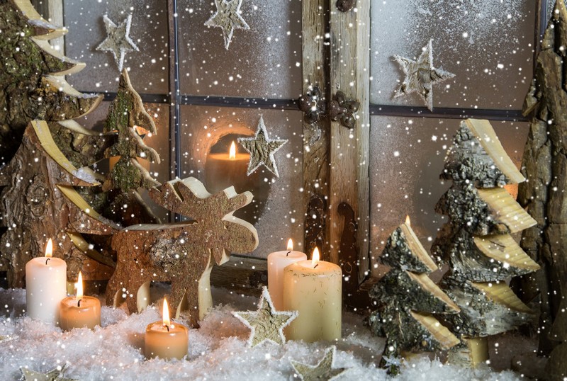 natural christmas window decoration of wood with snow.