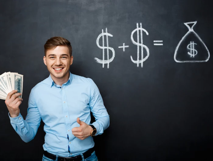 handsome man standing over blackboard with drawn dollar concept