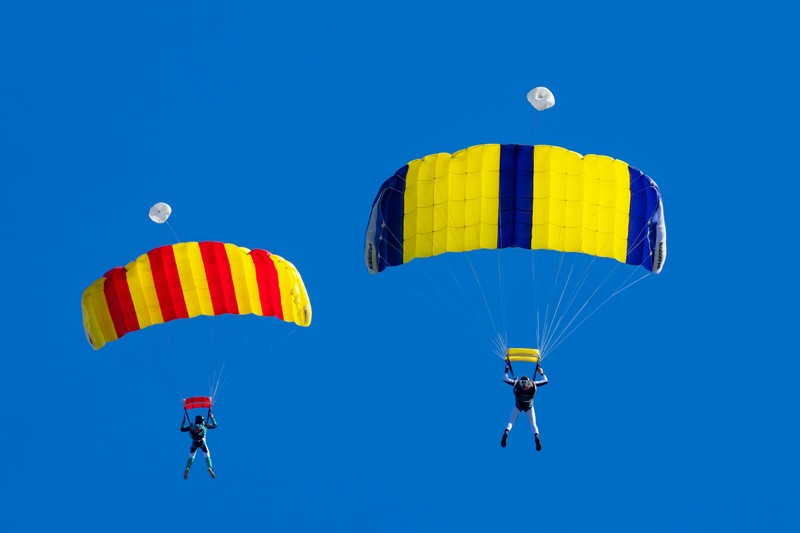 parachutists against a blue sky