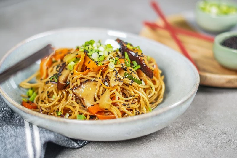 gemuesespaghetti im teller auf dem granittisch