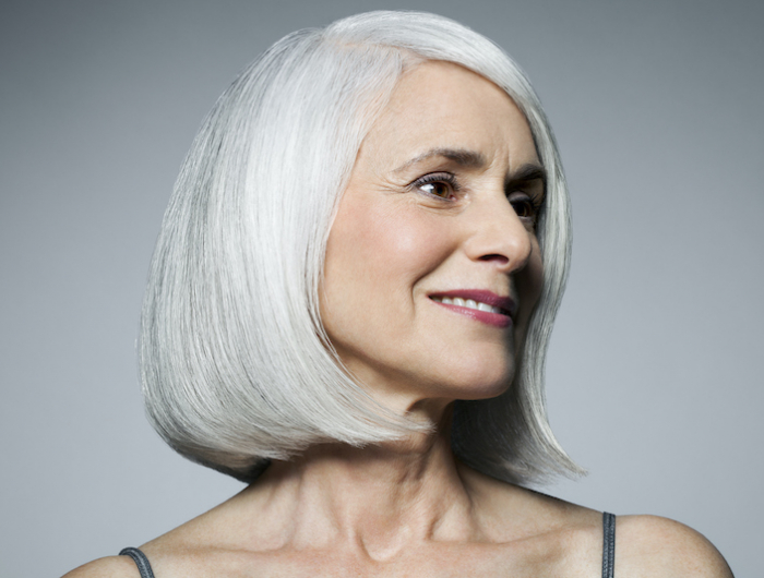 grey haired woman in 3/4 postion, portrait.