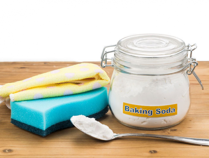 baking soda with sponge and towel for effective house cleaning.