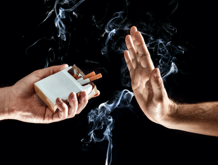 hands close up, stop smoking gesture, give up cigarettes, stop smoking. creative background. the con