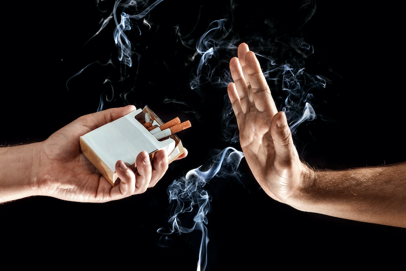 hands close up, stop smoking gesture, give up cigarettes, stop smoking. creative background. the con