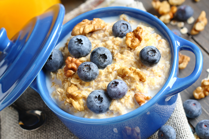 oatmeal with fresh blueberries over a rustic wooden background