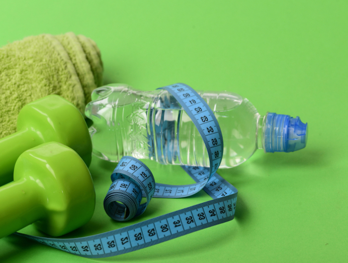 athletics and weight loss concept. dumbbells in bright green color