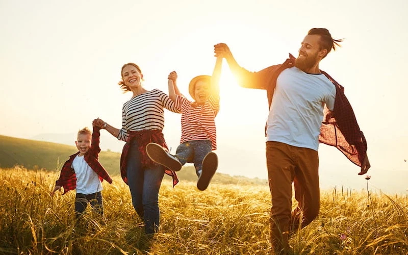 happy family: mother, father, children son and daughter on sunset