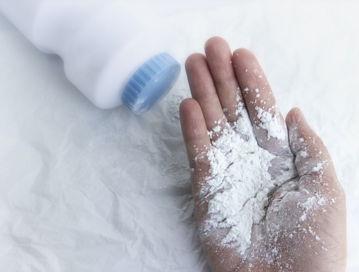 baby powder on mother's hand, dust dangerous for health concept.