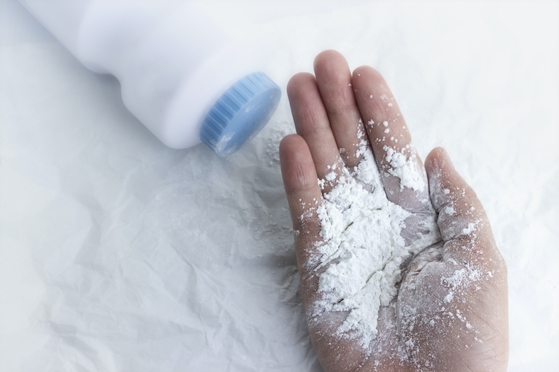 baby powder on mother's hand, dust dangerous for health concept.