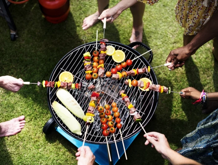 aerial view of a diverse group of friends grilling barbecue outdoors