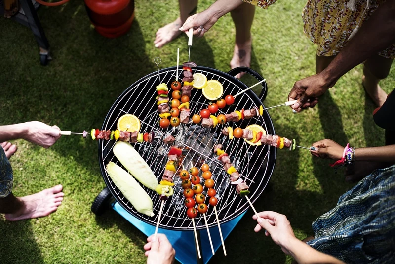 aerial view of a diverse group of friends grilling barbecue outdoors