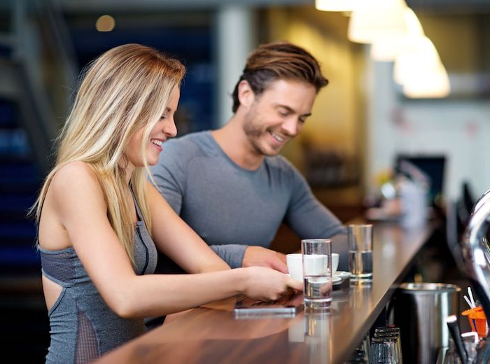 young couple at a gym at the bar
