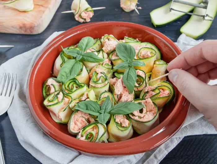 zucchini roellchen mit lachs und frischkaese rotes teller mit zucchini roellechen frisches basilikum