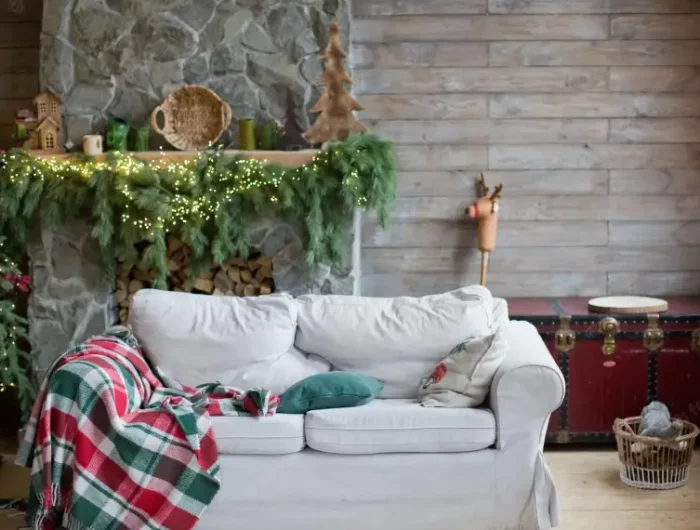 wie heißt die trendfarbe 2022 alpen chalet stil wohnzimmer mit rustikaler weihnachtsdeko trend 2022 weisses sofa kamin tannenzweige frisch