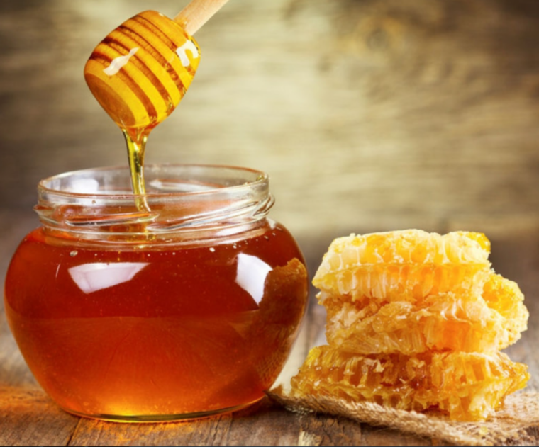 honig im glas mit holzloeffel für honig