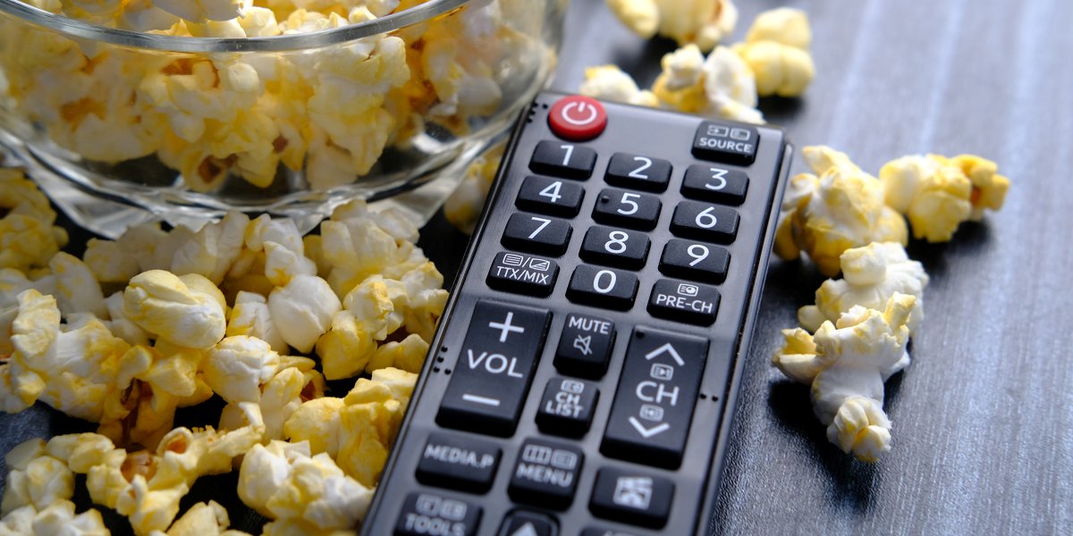 popcorn in a bowl with tv remote